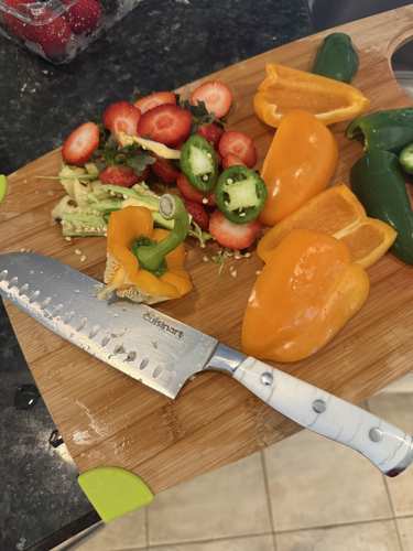 Fresh peppers and strawberries being prepared for salsa